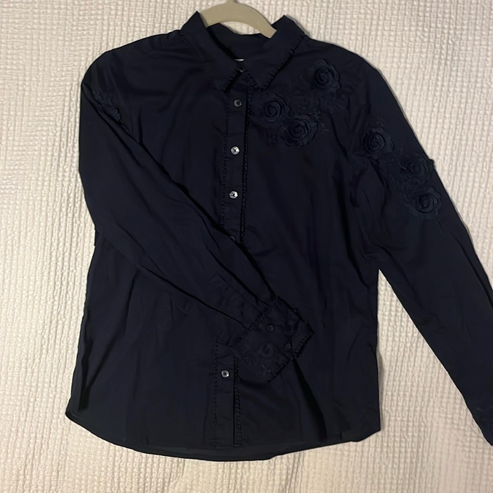 Chicos black button blouse with floral details.